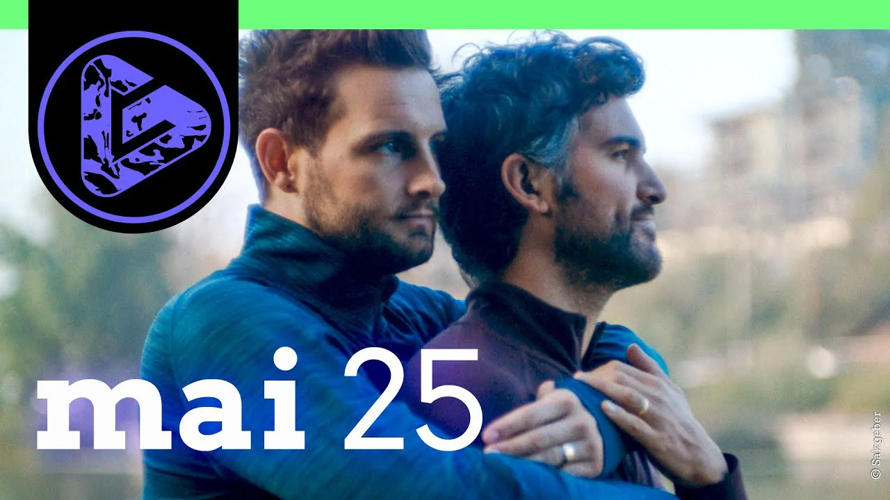 Zwei Männer in Sportkleidung schauen in die Ferne, Logo und Datum "mai 25" sind eingeblendet.